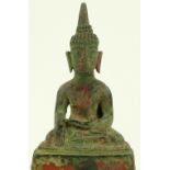 An Oriental verdigris bronze seated Buddha, traces