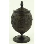 An Antique coconut cup and cover on stand, relief