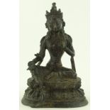 An Oriental patinated bronze seated Buddha, height