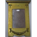 A brass framed wall mounted restaurant menu frame