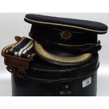 A Police Officer's cap and belt in circular tin ca