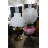 A Victorian pink glass oil lamp on cast-iron base