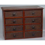 A Victorian stained wood table-top chest of 8 drawer