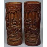 A pair of Oriental carved bamboo brush pots