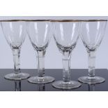 A set of 4 heavy wine glasses with gilded rims, he
