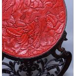 A large Chinese red lacquer plate, with relief exo