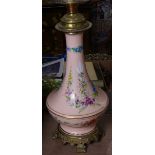 A 19th century porcelain and brass oil lamp, with