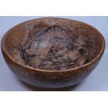 An African rough carved walnut bowl, diameter 15