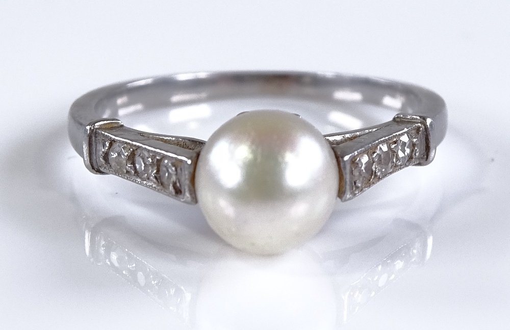 A platinum solitaire pearl ring, with diamond set