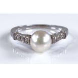 A platinum solitaire pearl ring, with diamond set