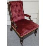 A Victorian mahogany-framed fireside armchair, wit