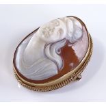 A high relief carved cameo brooch, depicting femal