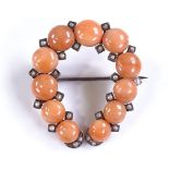 An unmarked gold coral and seed pearl horseshoe de