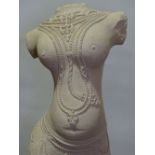 A large hand carved stone torso sculpture of the I