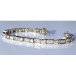 A 14ct white gold diamond tennis line bracelet, bezel set