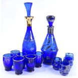 A gilded blue glass decanter, with 6 matching gobl