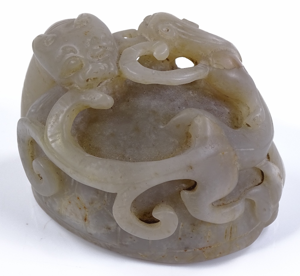 A Chinese carved and pierced jade dragon ornament,