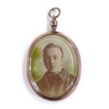 A 1920s 9ct rose gold framed memorial locket, with