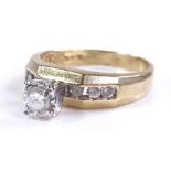 A 9ct gold solitaire diamond ring, with channel se