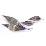 A silver leaf design brooch and pair of matching e