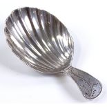 A small silver tea caddy spoon, with a shell shape