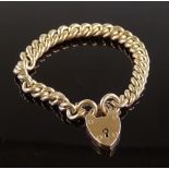 A heavy 9ct gold curb link heart-lock charm bracel