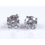A pair of 14ct white gold solitaire diamond ear st