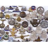 A collection of military sweetheart brooches, badg