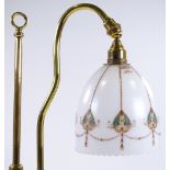 A brass rise and fall desk lamp with transfer deco