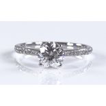 An 18ct white gold solitaire diamond ring, central