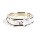 A 2-tone 9ct gold solitaire diamond ring, band wid