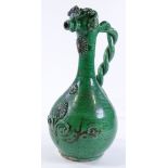 A Continental green glazed pottery flagon, with tw