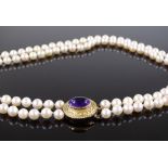 A standard long double-row cultured pearl necklace