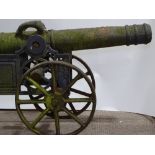 A weathered cast-iron ornamental garden cannon, in