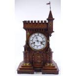 A 19th century German oak-cased mantel clock in th