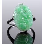 An 18ct white gold jade panel ring, floral carving