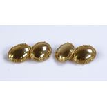 A pair of unmarked gold oval cufflinks, with bead