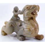 A Chinese carved stone figure riding a dragon, len