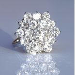 An 18ct white gold diamond cluster ring, set with
