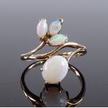 A 14ct gold cabochon opal floral design ring, sett