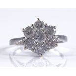 An 18ct white gold 7-stone diamond cluster ring, t