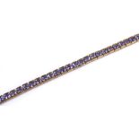 A 9ct gold tanzanite tennis line bracelet, length