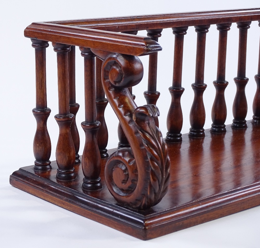 A reproduction mahogany desktop book rack, with ca