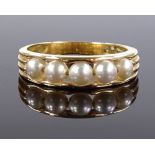 An unmarked gold 5-pearl band ring, setting height