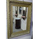 A Victorian gilt gesso-framed rectangular wall mir