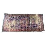 Antique Tabriz woollen carpet, deep blue field centred with a blue and red palmette medallion,