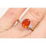 Fire opal and diamond cluster ring, the oval cut opal of approx.