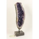 Brazilian amethyst geode, presented on a stand,