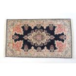 Indian silk rug, deep blue field with a central floral medallion,