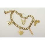 9ct gold curb link charm bracelet with padlock clasp and safety chain, supporting five gold charms,